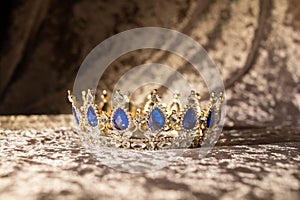 Royal  golden crown with blue stones. Jewellery