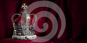 Royal golden crown with jewels on pillow on pink red background. Symbols of UK United Kingdom monarchy