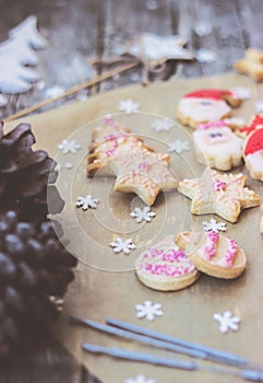 Royal icing decorated christmas cookies on wooden background;