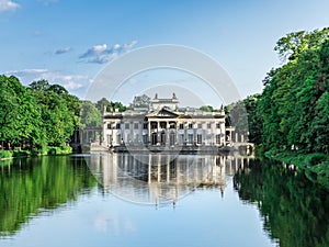 Royal Lazienki Park in Warsaw, Poland. Palace on the Water, Northern facade. Reflections of the palace in the pond on a summer day