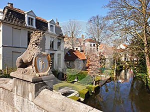 Royal lion`s sculpture on one of the local bridges in Brugges, Belgium