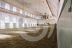 Royal manege with sand for horses in Denmark Copenhagen in territory Christiansborg Slot. Riding hall with sandy covering. Indoor