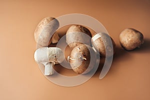 Royal mushroom champignons on beige background. vegetarian food.vegetarian high protein meal. whole raw cultivated brown