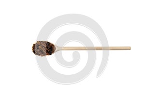 Royal raisins on wooden spoon isolated on white background. Spice and food ingredients