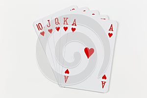 Royal straight flush in hearts, playing cards isolated on white background