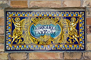 Royal Tabacco factory sign - Fabrica Real de Tabacos - on wall in Seville, Andalusia, Spain