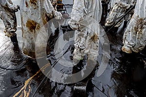 Royal Thai Navy and local volunteers cleaning up a beach from a oil slick on Ao Phrao beach on Samed Island, rayong, Thailand. An