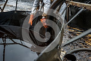 Royal Thai Navy and local volunteers cleaning up a beach from a oil slick on Ao Phrao beach on Samed Island, rayong, Thailand. An