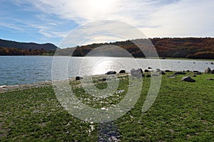 Rocks on the shore and mountains in the Morales reservoir on the Ruta de los CastaÃÂ±os in Rozas de Puerto Real, Madrid. Spain photo