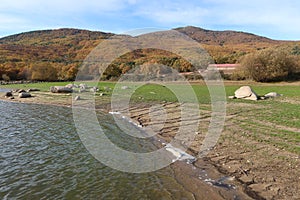 White foam on one of the banks of the Morales reservoir in Rozas de Puerto Real, Madrid. Spain photo