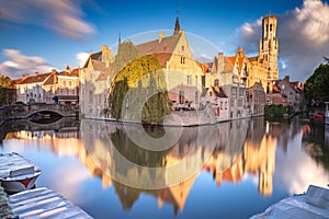 Rozenhoedkaai canal reflection at sunrise and blurred clouds, Bruges