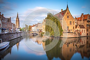 Rozenhoedkaai canal reflection at sunrise and blurred clouds, Bruges