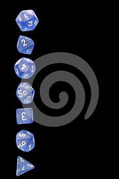 RPG set blue dice for playing role playing games on black blackground.