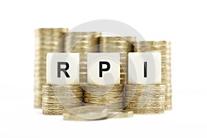 RPI (Retail Price Index) on Coin Stacks Isolated White Backgroun