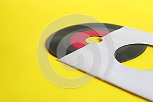 45rpm Vinyl Record with Sleeve. close up vinyl on yellow background. photo