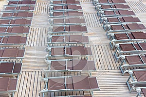 Rrows of brown deck chairs closed on cruise ship