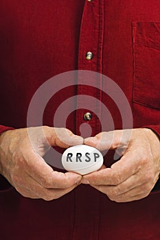 RRSP on egg held by man