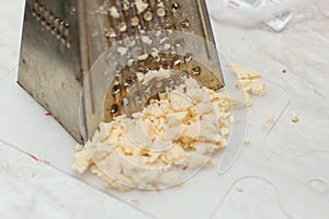 Rub the cheese on an old grater