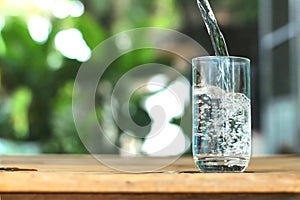 The rubbed water is poured into the glass. Drinking enough water is good for your health.