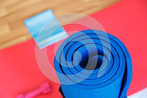 Rubber Band with Red Pilates Mat on Wood