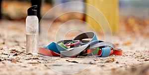 Rubber bands and a bottle of water on a sports ground