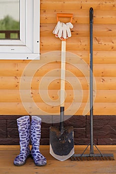 Rubber boots with shovel and rake