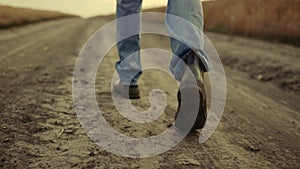 Rubber boots walking rural road closeup at countryside alone. Go away man walker