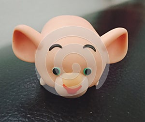 A rubber doll in the shape of a pig on a black background