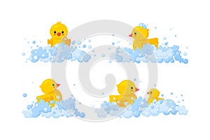 Rubber duck family in soap foam isolated in white background. Set of yellow plastic duck toys in suds, parent and baby