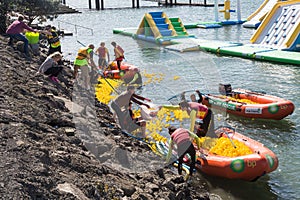 People in inflatable boats collecting thousands of rubber ducks after a race