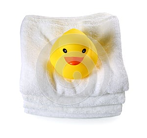 Rubber duck on white towels