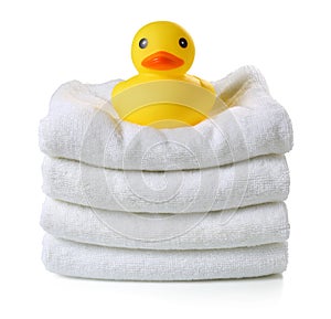 Rubber duck on white towels