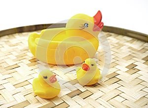 Rubber ducks on the bamboo woven basket isolated