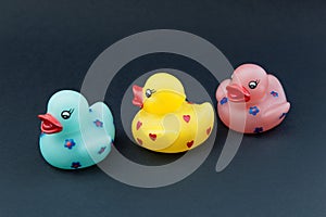 Rubber ducks on black background