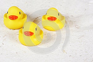 Rubber ducks in the sand at the beach