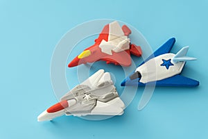 Rubber fighter plane toy display on blue background view