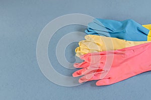 Rubber gloves for cleaning or washing on the blue background closeup photo