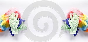 Rubber gloves, the duster and microfiber cloth on light background