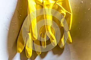 Rubber gloves with long cuffs on the sink close-up hands protection for all general cleaning tasks - Image