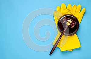 .Rubber gloves and mallet on a blue background. Concept of litigation at a cleaning company photo