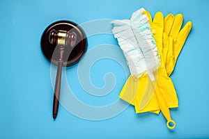 .Rubber gloves and mallet on a blue background. Concept of litigation at a cleaning company photo