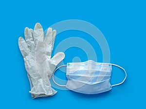 Rubber gloves and medical mask on blue background. The ncov-19 coronavirus pandemic. Anti-virus protection against flu photo
