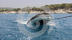 Rubber inflatable dinghy boat been dragged behind a yacht during sailing.