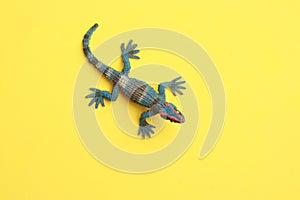 Rubber lizard toy isolated on yellow background