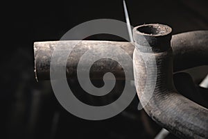 Rubber pipes and hoses leading from the car radiator to the engine, view of the engine from below. old worn rubber car