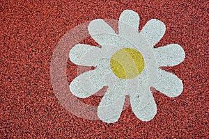 Rubber playground surface with white flower