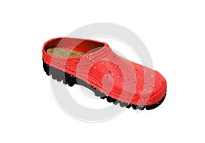 Rubber shoes isolate on a white back. Colored rubber slippers on a tractor sole. Shoes for the garden, beach and housework