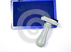 Rubber stamp and blue ink box isolated on white