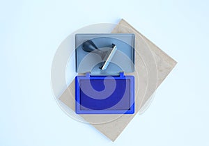 Rubber stamp and Blue Ink cartridges on brown book against white background