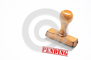Rubber stamp with pending sign on white background